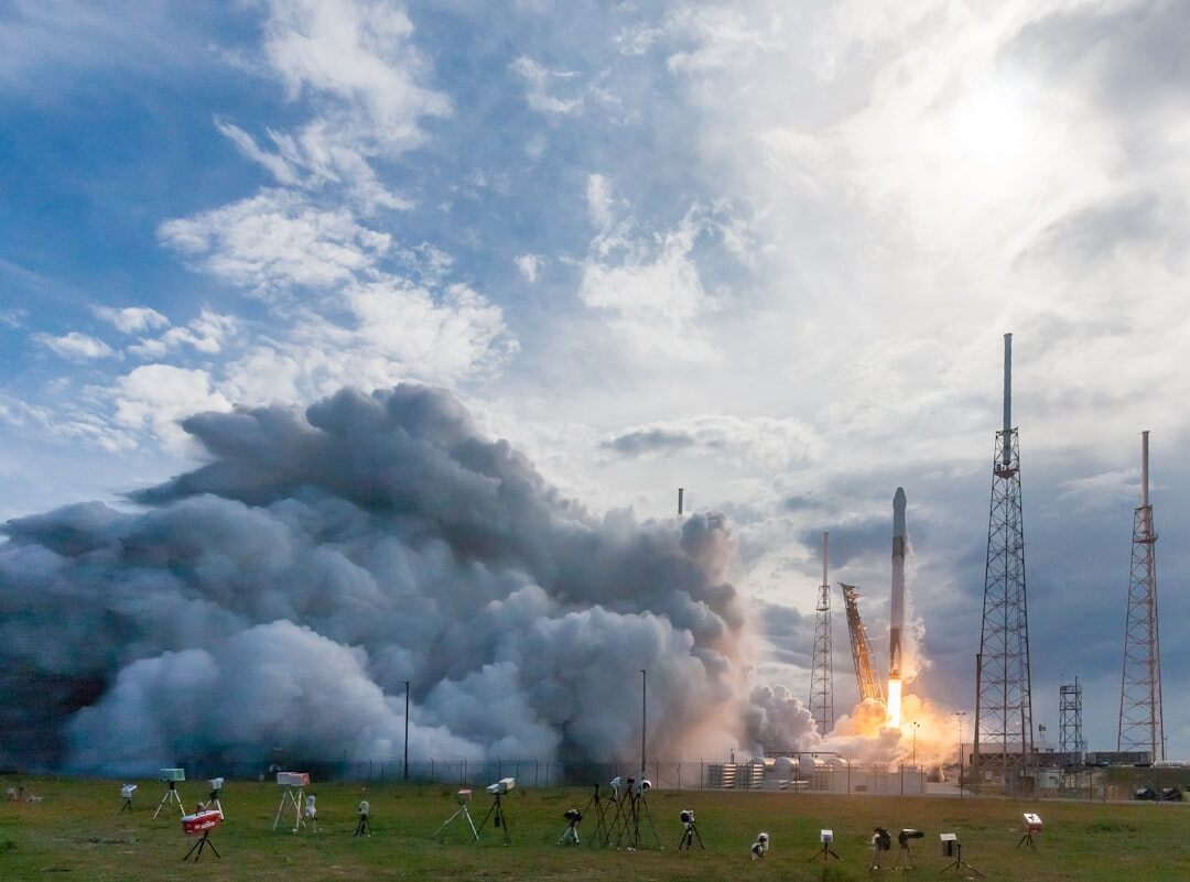 Rocket launch at sunset with technology overlay